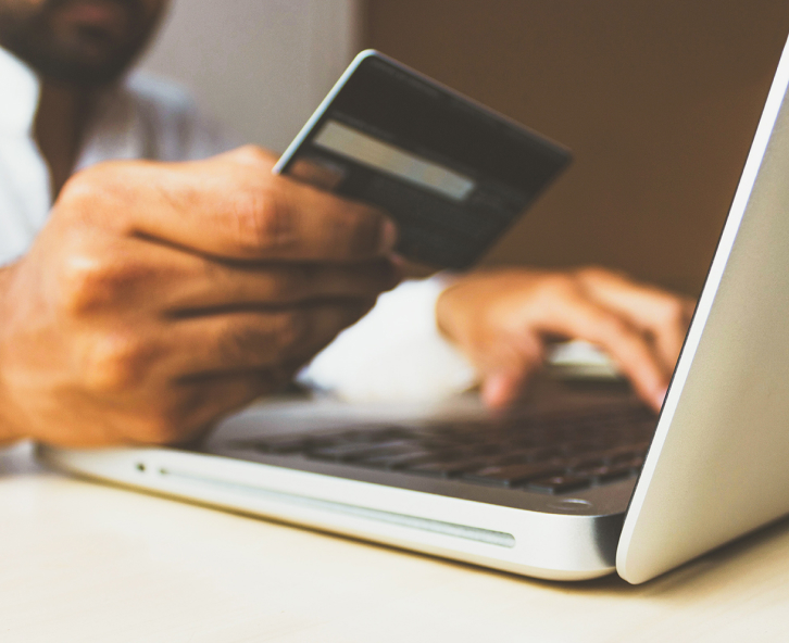 man reading credit card while on computer