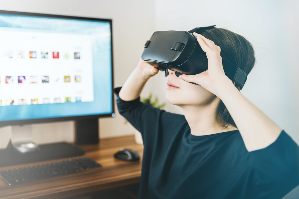 woman using VR headset in office