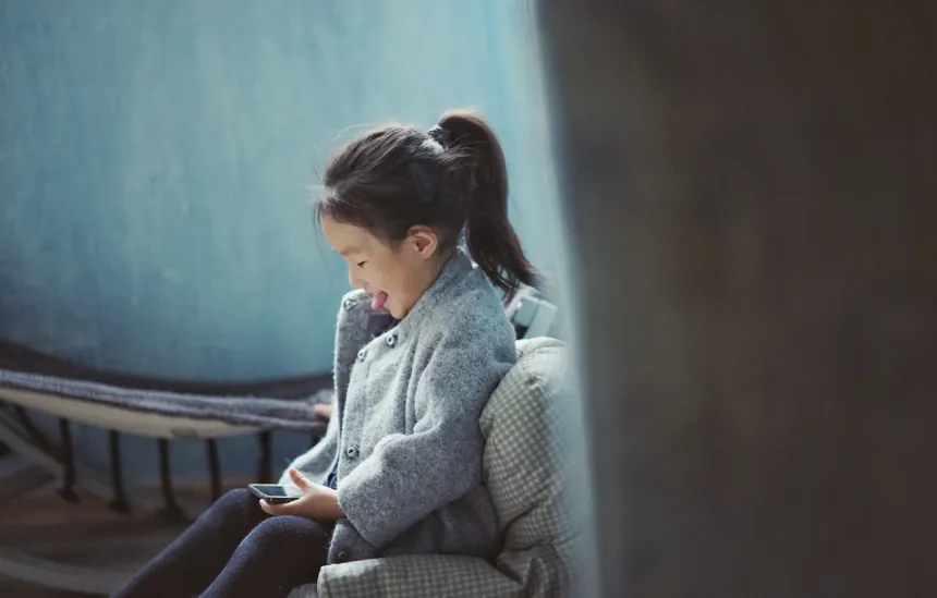 little girl playing on phone