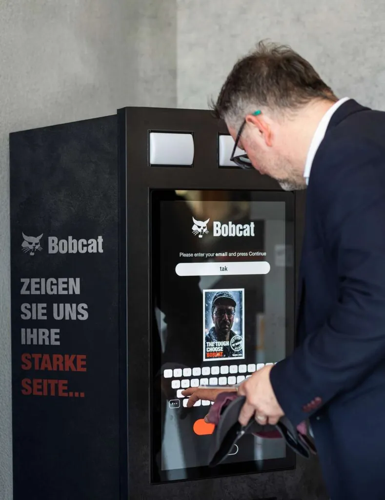 AI photo booth activation at Bobcat's BAUMA 2025 stand generating a branded personalised image.